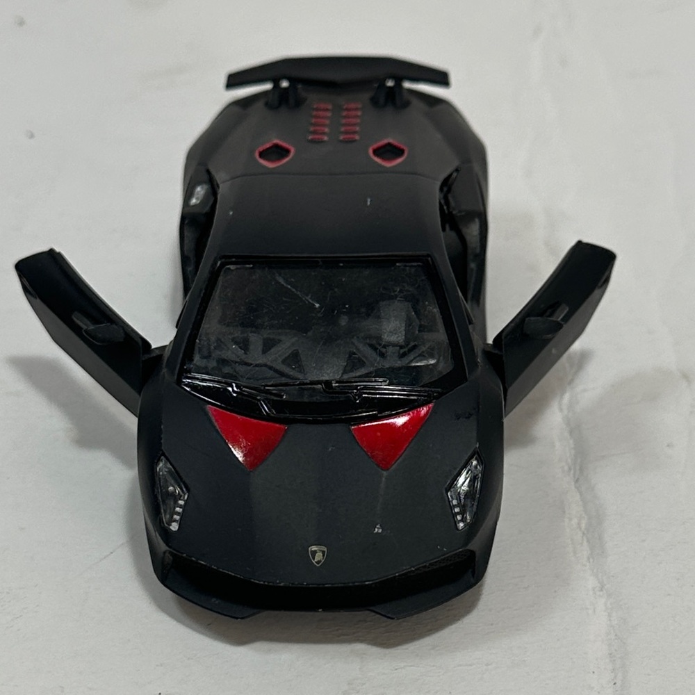 Lamborghini Sesto Elemento Sleek Black and Red Toy Sports Car
